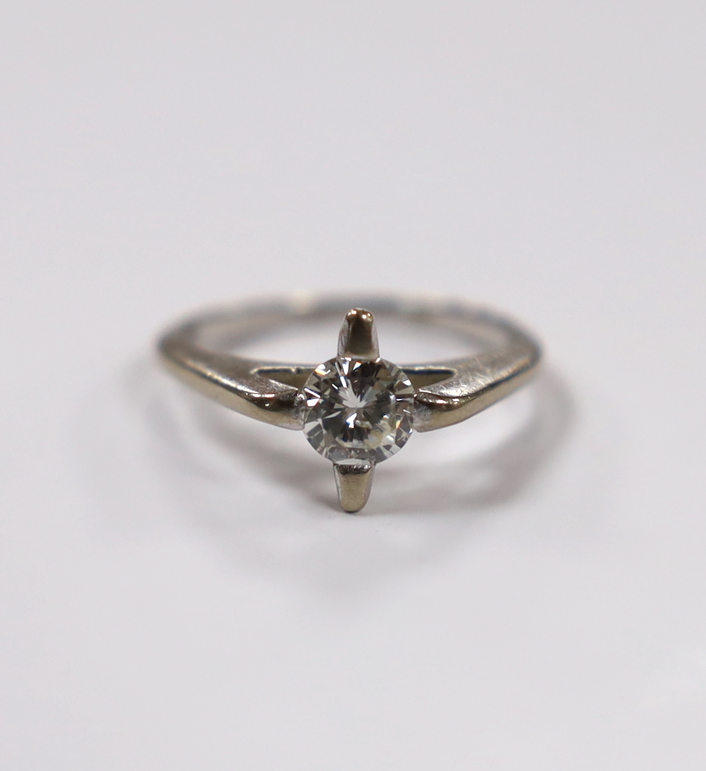 A modern white metal and solitaire diamond set ring, size K, gross weight 3.5 grams.